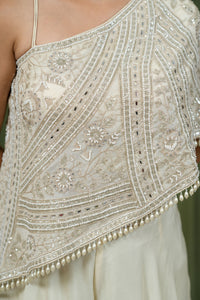 Close-up of baguette crystal and pearl bead embroidery on ivory cape top