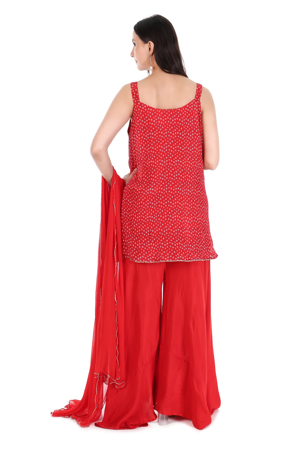 Front view of scarlet red embellished sleeveless kurta with palazzo trousers and sheer dupatta