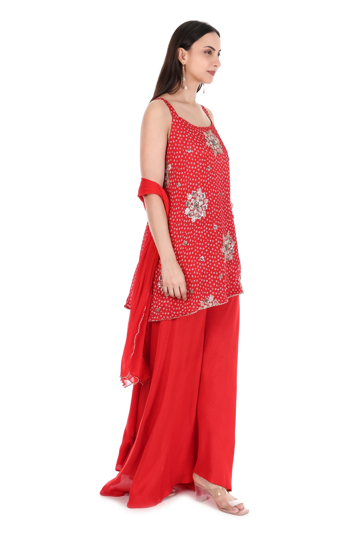 Scarlet red kurta palazzo set showing metallic floral embellishments and flowing dupatta