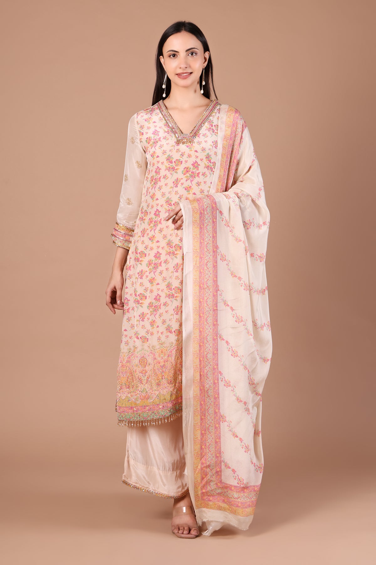 Ivory floral kurta set showing pastel hem border and flowing blush-bordered dupatta