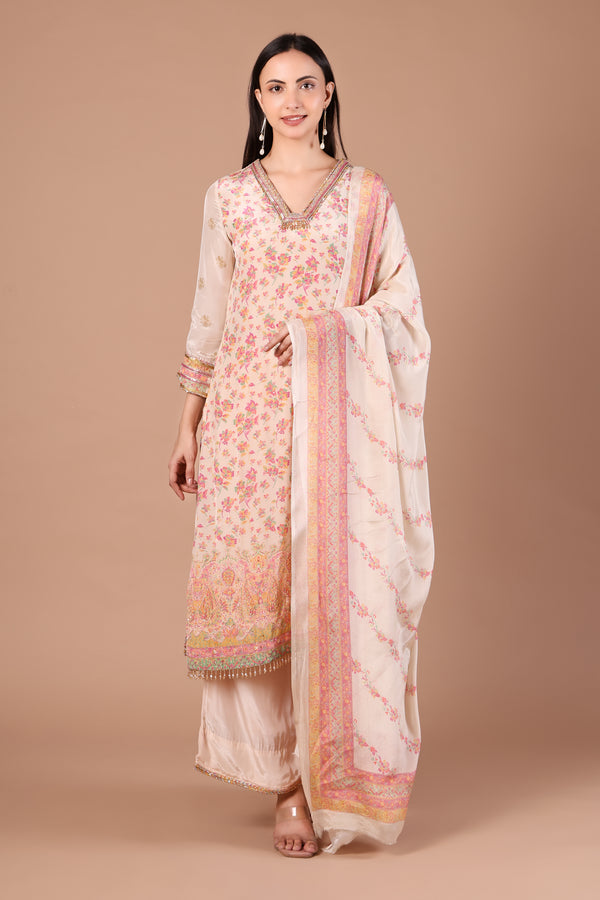 Ivory floral kurta set showing pastel hem border and flowing blush-bordered dupatta