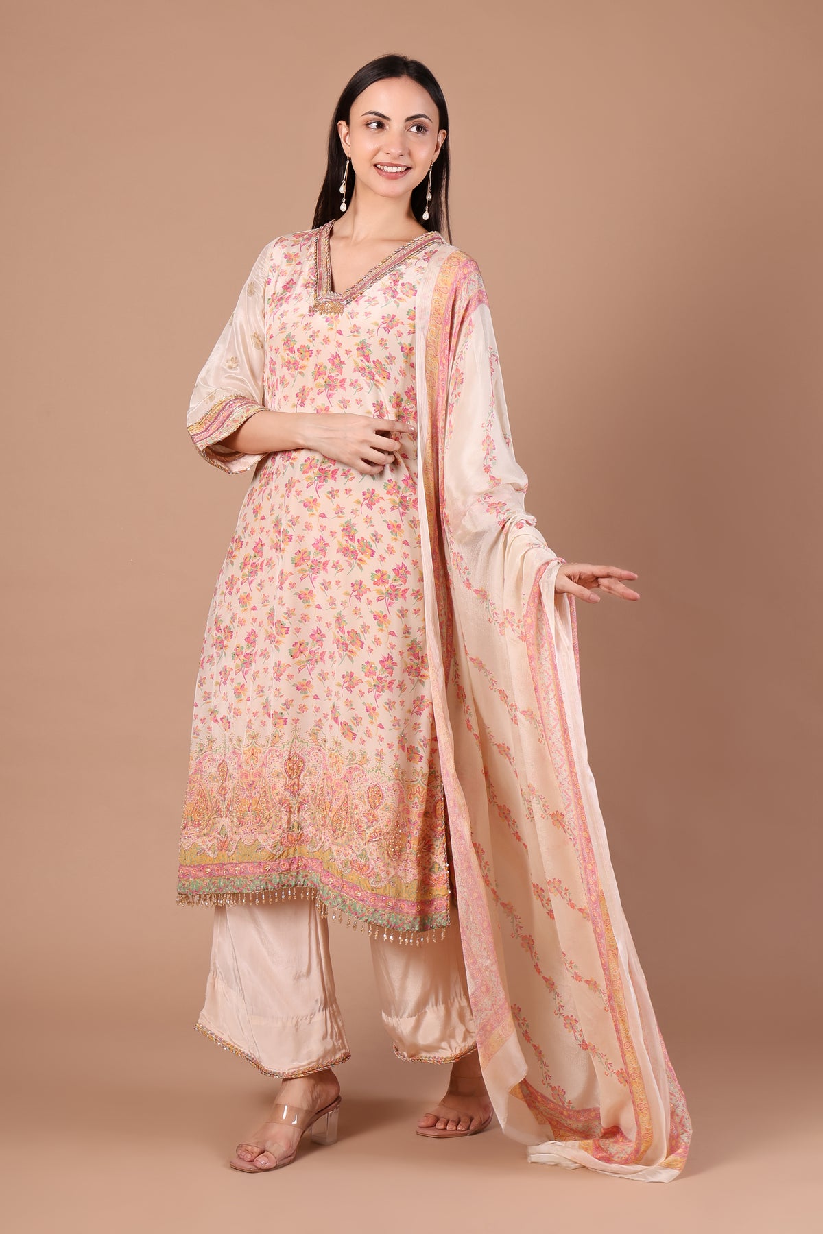 Side view of ivory and blush kurta set showing patterned cuffs and wide-leg trousers