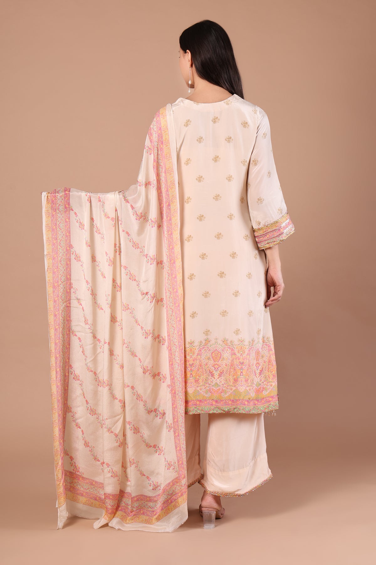Back view of ivory kurta with scattered motifs and floral bordered dupatta