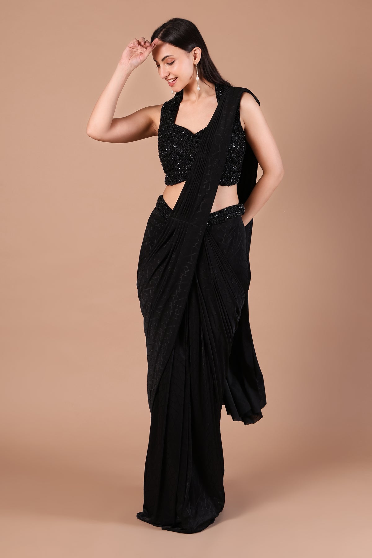 Front view of black saree look with shimmering blouse and gathered drape